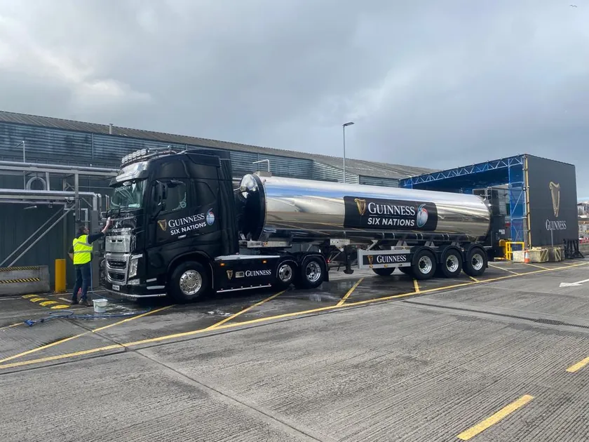 Guinness Six Nations branding across a black truck and polished tanker outside the Guinness brewery