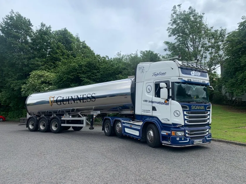 Front three-quarter view of the truck and Guinness-branded tanker
