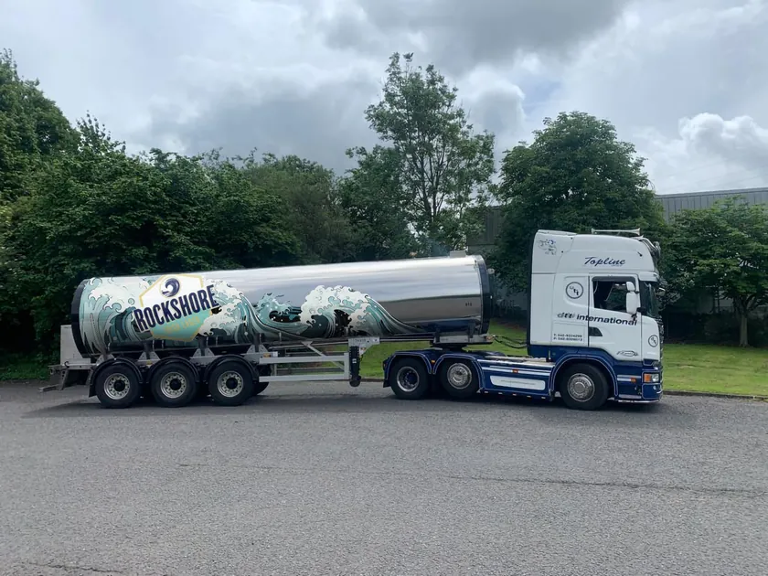 Rockshore tanker wrap concept with turquoise illustrated waves and a large Rockshore Irish Lager badge