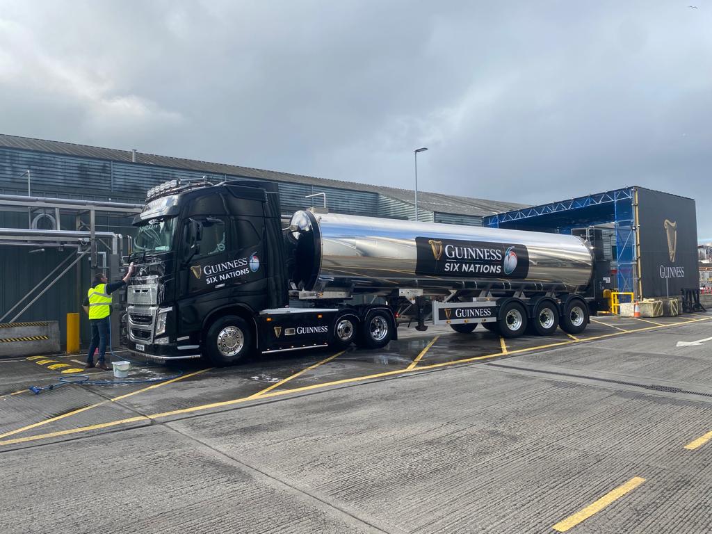 Guinness Six Nations branding across a black truck and polished tanker outside the Guinness brewery